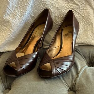 Woman’s brown peep toe heel.